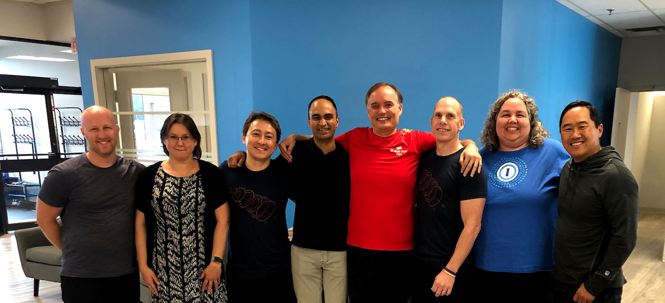 Group hug after sealing the deal in our St. Thomas, Ontario office. From left to right: Dan Levine, Natalia Karimova, Roustem Karimov, Arun Mathew, Dave Teare, Jeff Shiner, Sara Teare, Rich Wong.