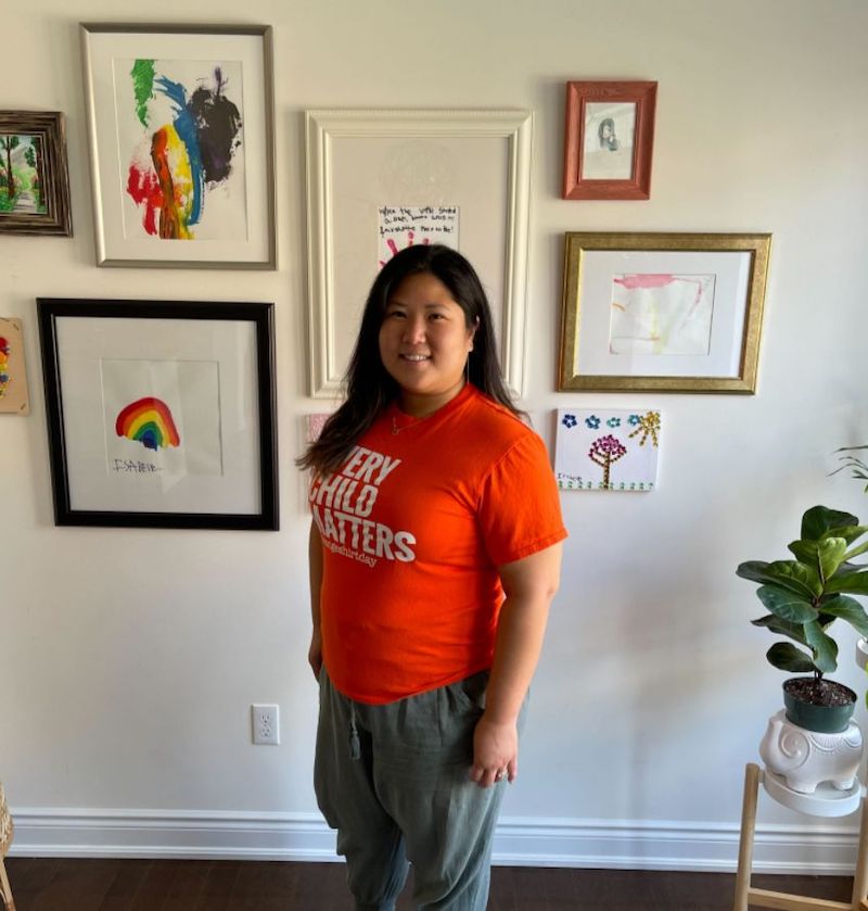 1Password staff wearing an orange shirt with the phrase 'Every Child Matters'.