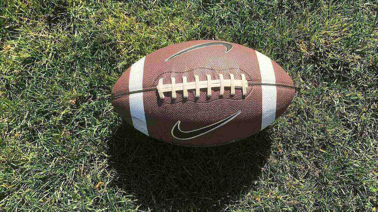 A photo of a football on the ground.