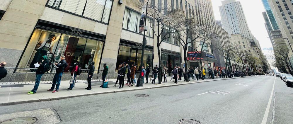 An image of people in line waiting for a record store to open.