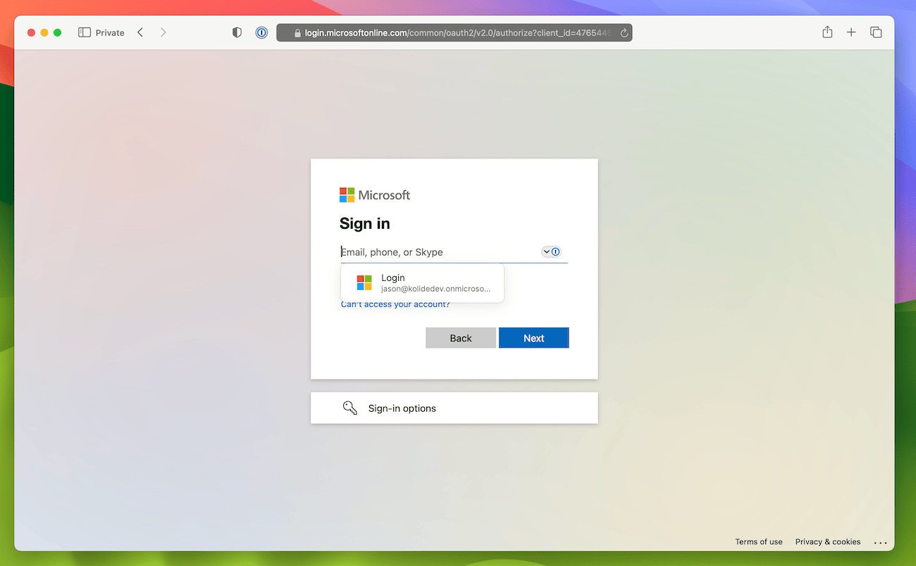 The Microsoft sign-in page, with 1Password offering to autofill credentials